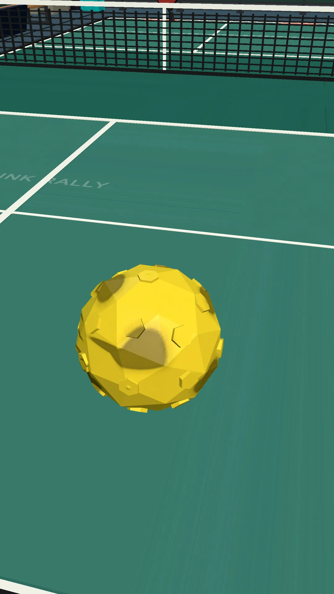 Dink Rally close view of the yellow pickleball just above the court surface near the net.