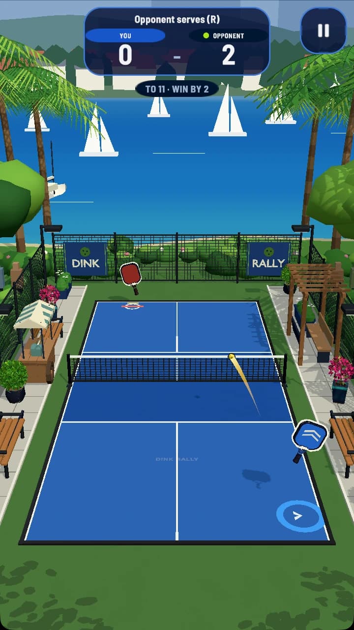 Dink Rally mid-rally on the blue Lakeside court, opponent leading 2 to 0: the player's return crosses the net with a short trail, both paddles in view, palms and sailboats behind, and a To 11, Win by 2 tab under the score.
