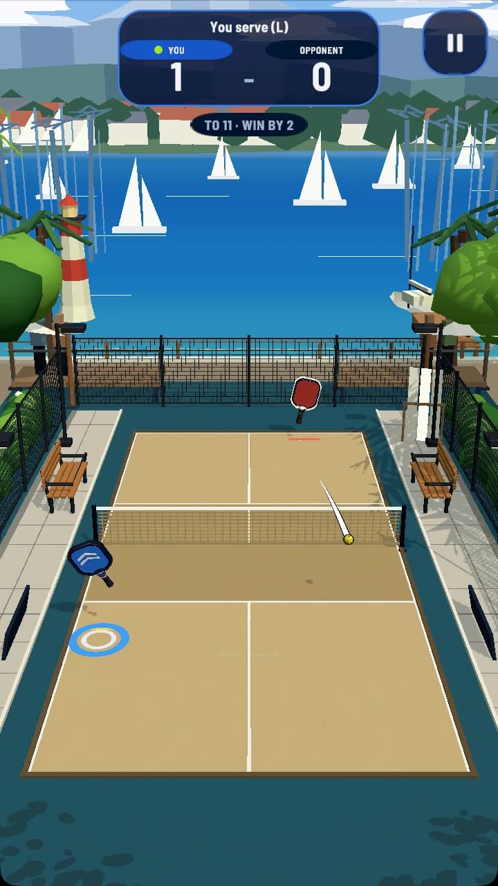 Dink Rally mid-rally on the sand-toned Marina court at 1 to 0, the ball crossing the net, a lighthouse and harbour masts behind.